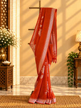 A burnt orange tussar georgette saree with bold floral bouquets woven all over in silver zari