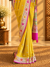 A bright yellow and Rani pink combination tussar georgette saree with a paithani border and pallu