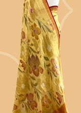 A lemon yellow khaddi Georgette saree with upada floral bootas all over which have detailed hand painted patterns all over and a contrast red kanni . Shop the best collection of authentic, handwoven, pure benarasi sarees with Roliana New Delhi