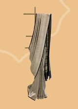 A beautiful silk brocade saree with all over naqshi jaal and an interesting lace border and pallu. Shop the best collection of authentic, handwoven, pure benarasi sarees with Roliana New Delhi