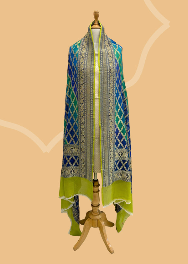  A beautiful barfi jaal Georgette dupatta hand painted shaded of blue and teal with a contrast gold kanni. Shop the best of Banarasi sarees, dupattas and lehengas at Roliana New Delhi