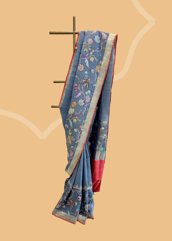 Gray tussar Georgette saree with pyramid border and a tissue double border with upada floral design and a red kanni and blouse. Shop the best collection of authentic, handwoven, pure benarasi sarees with Roliana New Delhi