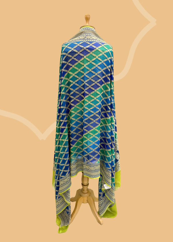  A beautiful barfi jaal Georgette dupatta hand painted shaded of blue and teal with a contrast gold kanni. Shop the best of Banarasi sarees, dupattas and lehengas at Roliana New Delhi