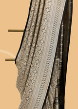 A beautiful silk brocade saree with all over naqshi jaal and an interesting lace border and pallu. Shop the best collection of authentic, handwoven, pure benarasi sarees with Roliana New Delhi