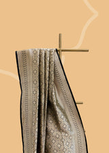 A beautiful silk brocade saree with all over naqshi jaal and an interesting lace border and pallu. Shop the best collection of authentic, handwoven, pure benarasi sarees with Roliana New Delhi