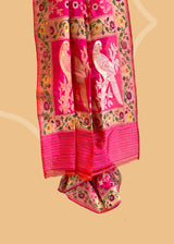 A beautiful Rani pink popat saree with ektaara kangoora jaal and an ornate Bel weave in meenakari border and pallu pure Banarasi sari. Shop the best collection of authentic, handwoven, pure benarasi sarees with Roliana New Delhi