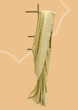 A cream yellow silk saree with brocade pyramid weave interspersed with pale yellow and firozi detailed flowers and a geometric pallu and border. A pure Banarasi wedding Sari Shop the best collection of authentic, handwoven, pure benarasi sarees with Roliana New Delhi