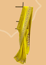 A fresh mustard yellow saree with delicate woven flowers and border in contrast meenakari colours. A pure Banarasi Sari Shop the best collection of authentic, handwoven, pure benarasi sarees with Roliana New Delhi