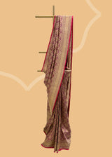A wine coloured silk brocade saree with barfi weave in zari and a contrast maroon kanni pure Banarasi Sari Shop the best collection of authentic, handwoven, pure benarasi sarees with Roliana New Delhi