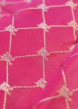 A handloom Rani pink barfi jaal in tanchoi weave with delicate meenakari flowers in satin silk. Shop pure handloom Benarasi Fabric thaans at Roliana Weaves New Delhi