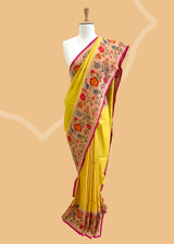 A delicate sunflower yellow saree with a striking meenakari floral border and delicate zari bootis all over. A pure Banarasi Sari Shop the best collection of authentic, handwoven, pure benarasi sarees with Roliana New Delhi