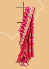 A beautiful Rani pink popat saree with ektaara kangoora jaal and an ornate Bel weave in meenakari border and pallu pure Banarasi sari. Shop the best collection of authentic, handwoven, pure benarasi sarees with Roliana New Delhi
