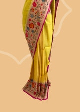 A delicate sunflower yellow saree with a striking meenakari floral border and delicate zari bootis all over. A pure Banarasi Sari Shop the best collection of authentic, handwoven, pure benarasi sarees with Roliana New Delhi