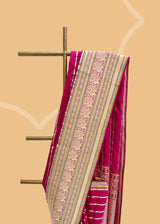 A striking pink satin saree with woven horizontal stripes and a stunning Kanjeevaram inspired border with zari brocade detailing and peacocks Shop the best collection of authentic, handwoven, pure benarasi sarees with Roliana New Delhi