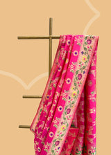 A beautiful Rani pink popat saree with ektaara kangoora jaal and an ornate Bel weave in meenakari border and pallu pure Banarasi sari. Shop the best collection of authentic, handwoven, pure benarasi sarees with Roliana New Delhi