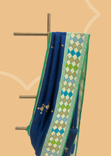 Navy blue phulkari weave booti saree with a striking green phulkari border and pallu. Shop the best collection of authentic, handwoven, pure benarasi sarees with Roliana New Delhi