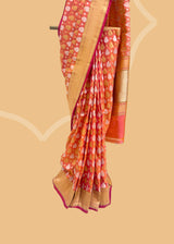 a traditional peach pink shot saree in silk with Sona roopa zari bootis and a chevron zari border and pallu. A pure Banarasi wedding Sari Shop the best collection of authentic, handwoven, pure benarasi sarees with Roliana New Delhi