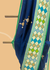Navy blue phulkari weave booti saree with a striking green phulkari border and pallu. Shop the best collection of authentic, handwoven, pure benarasi sarees with Roliana New Delhi