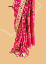 A beautiful Rani pink popat saree with ektaara kangoora jaal and an ornate Bel weave in meenakari border and pallu pure Banarasi sari. Shop the best collection of authentic, handwoven, pure benarasi sarees with Roliana New Delhi