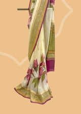 ivory cream saree in Georgette with zari bootis and border and hand painted irises in wine colour all over the saree.. A pure Banarasi wedding Sari Shop the best collection of authentic, handwoven, pure benarasi sarees with Roliana New Delhi