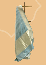 A beautiful powder blue satin tanchoi saree with silver and gold detalling of bootis and border. A pure Banarasi wedding Sari Shop the best collection of authentic, handwoven, pure benarasi sarees with Roliana New Delhi