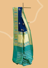 Navy blue phulkari weave booti saree with a striking green phulkari border and pallu. Shop the best collection of authentic, handwoven, pure benarasi sarees with Roliana New Delhi