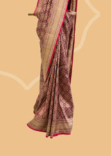 A wine coloured silk brocade saree with barfi weave in zari and a contrast maroon kanni pure Banarasi Sari Shop the best collection of authentic, handwoven, pure benarasi sarees with Roliana New Delhi