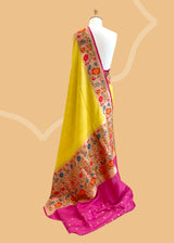 A delicate sunflower yellow saree with a striking meenakari floral border and delicate zari bootis all over. A pure Banarasi Sari Shop the best collection of authentic, handwoven, pure benarasi sarees with Roliana New Delhi