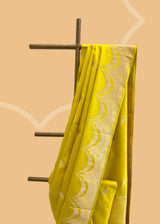 A lime green soft silk saree with small zari bootis all over and a beautiful trellis border with scallops and flowers.. A pure Banarasi Sari Shop the best collection of authentic, handwoven, pure benarasi sarees with Roliana New Delhi