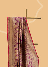 A wine coloured silk brocade saree with barfi weave in zari and a contrast maroon kanni pure Banarasi Sari Shop the best collection of authentic, handwoven, pure benarasi sarees with Roliana New Delhi