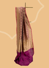 A wine coloured silk brocade saree with barfi weave in zari and a contrast maroon kanni pure Banarasi Sari Shop the best collection of authentic, handwoven, pure benarasi sarees with Roliana New Delhi