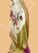 ivory cream saree in Georgette with zari bootis and border and hand painted irises in wine colour all over the saree.. A pure Banarasi wedding Sari Shop the best collection of authentic, handwoven, pure benarasi sarees with Roliana New Delhi