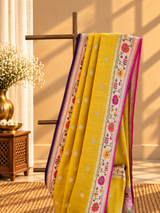 A bright yellow and Rani pink combination tussar georgette saree with a paithani border and pallu
