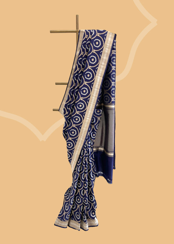 This Ink Blue Pure Silk Benarasi Saree is crafted from pure soft silk and handwoven with intricate trellis kangoora jaal in gold and silver zari..  Shop the best collection of authentic, handwoven, pure benarasi sarees with Roliana New Delhi