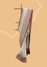 A silver tissue saree on very soft fabric with delicate woven zari booties and offset with a wine coloured jamali work border and pallu . Shop the best collection of authentic, handwoven, pure benarasi sarees with Roliana New Delhi