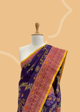 This multi-weave saree features an eggplant purple hue with a stunning kinkhab design.  Shop the best collection of authentic, handwoven, pure benarasi sarees with Roliana New Delhi