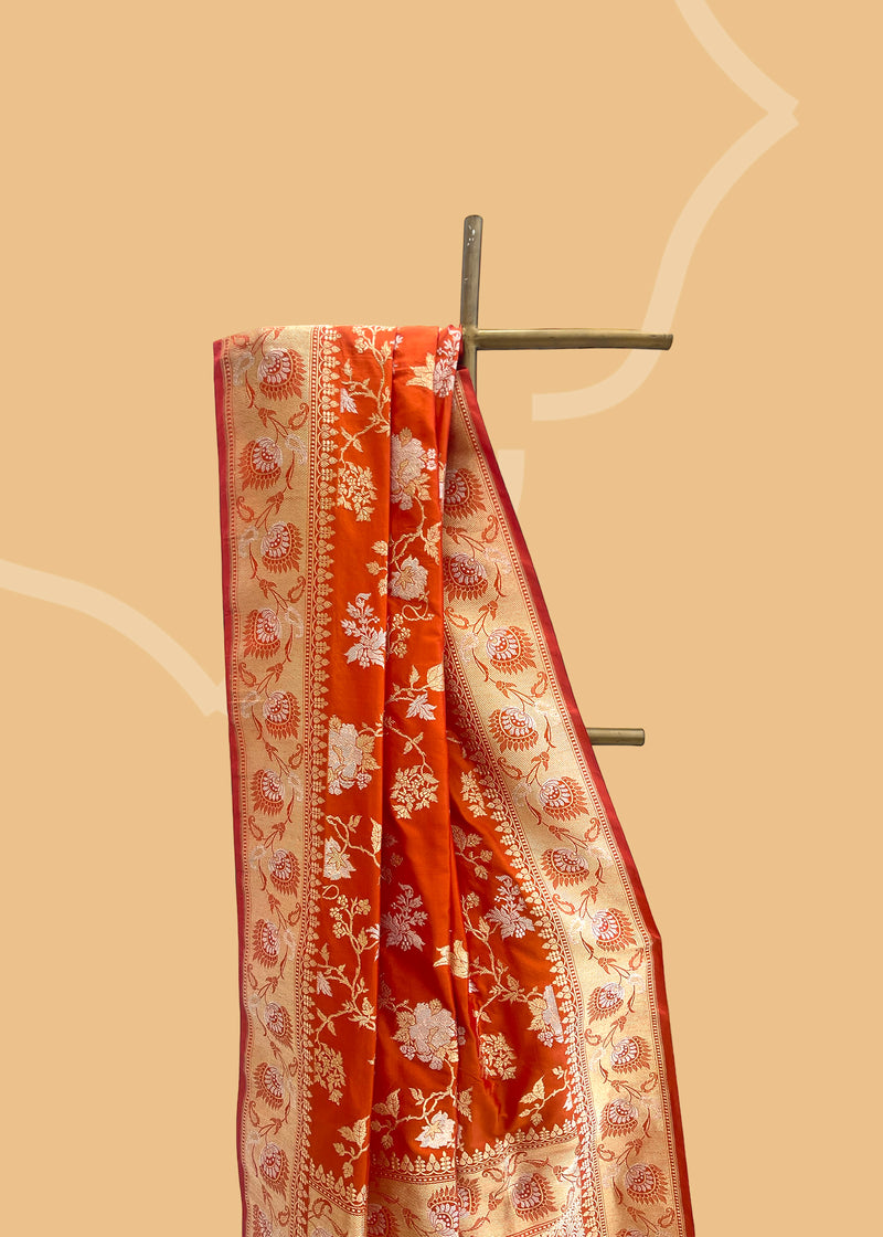 Burnt Orange Katan Silk Benarasi Saree, a stunning and unique garment made with pure handwoven silk. Shop the best collection of authentic, handwoven, pure benarasi sarees with Roliana New Delhi