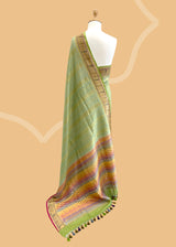 A pista green vertical stripe zari woven saree in dull gold with a vibrant meenakari paithani border and a hand-painted stripe pallu in multicolour..  Shop the best collection of authentic, handwoven, pure benarasi sarees with Roliana New Delhi