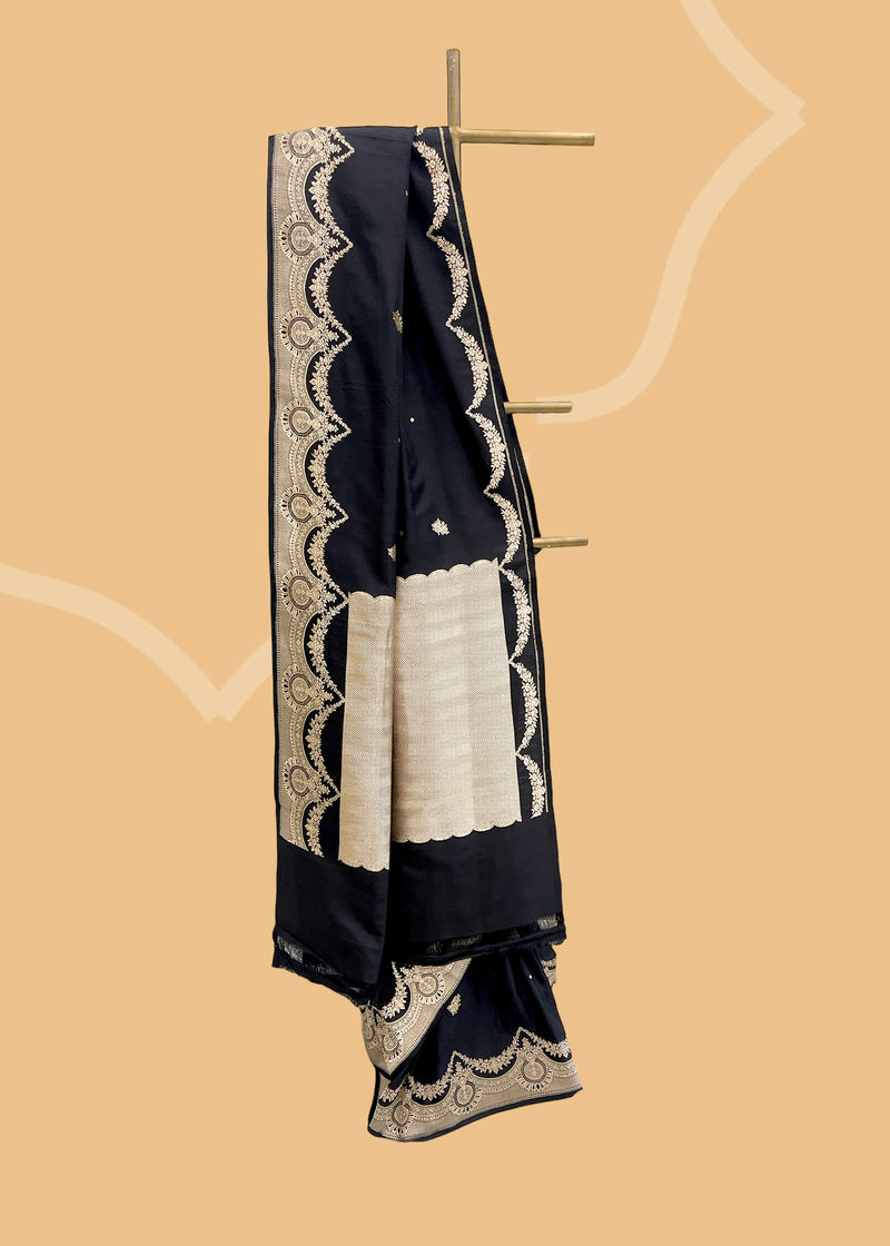 An elegant black mashru silk saree with delicate woven zari bootas and kangoora border and pallu. Shop the best collection of authentic, handwoven, pure benarasi sarees with Roliana New Delhi