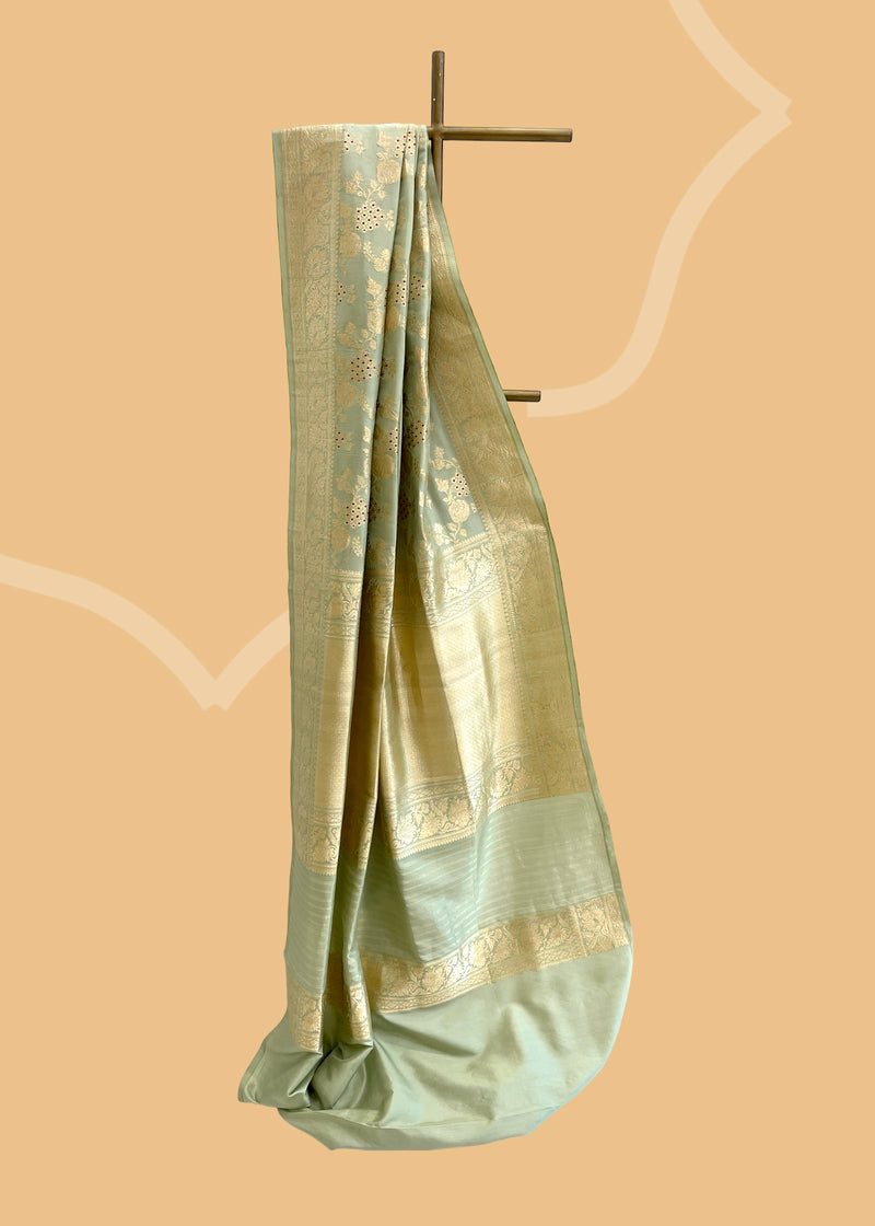 An ektaara handwoven pista green silk saree with a very delicate antique jaal and small meenakari detailing bringing in mind a very nostalgic time era gone by. Shop the best collection of authentic, handwoven, pure benarasi sarees with Roliana New Delhi
