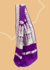 This exquisite Purple Mashru Silk Pure Zari Benarasi Saree is handwoven in satin silk by Roliana. Shop the best collection of authentic, handwoven, pure benarasi sarees with Roliana New Delhi