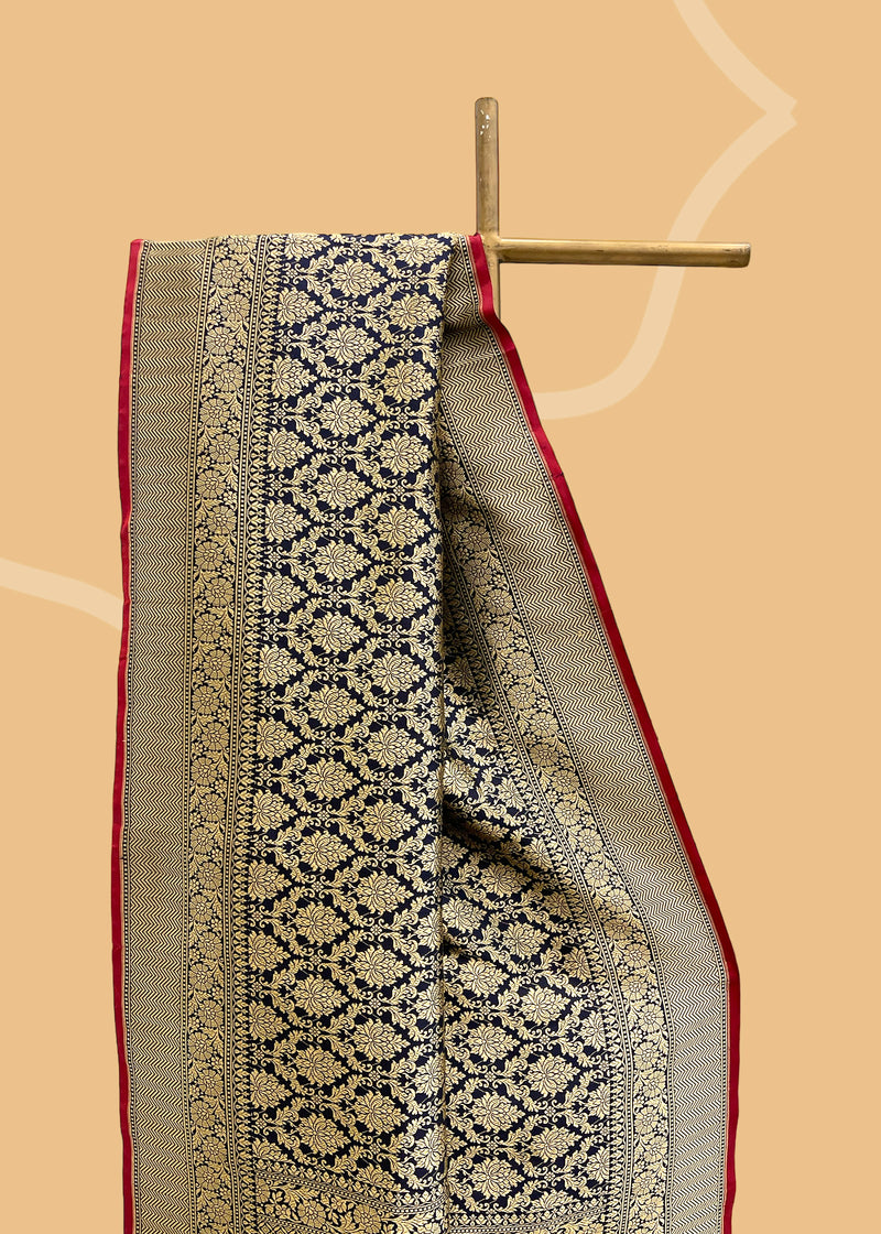  Indian luxury with this elegant Ink Blue Benarasi saree from Roliana. Handwoven in pure silk with a brocade oriental jaal in subdued gold zari,