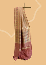 A blush pink tissue woven saree with small woven zari booties and a beautiful intricate meenakari border and pallu in soft rose pink satin fabric. Shop the best collection of authentic, handwoven, pure benarasi sarees with Roliana New Delhi