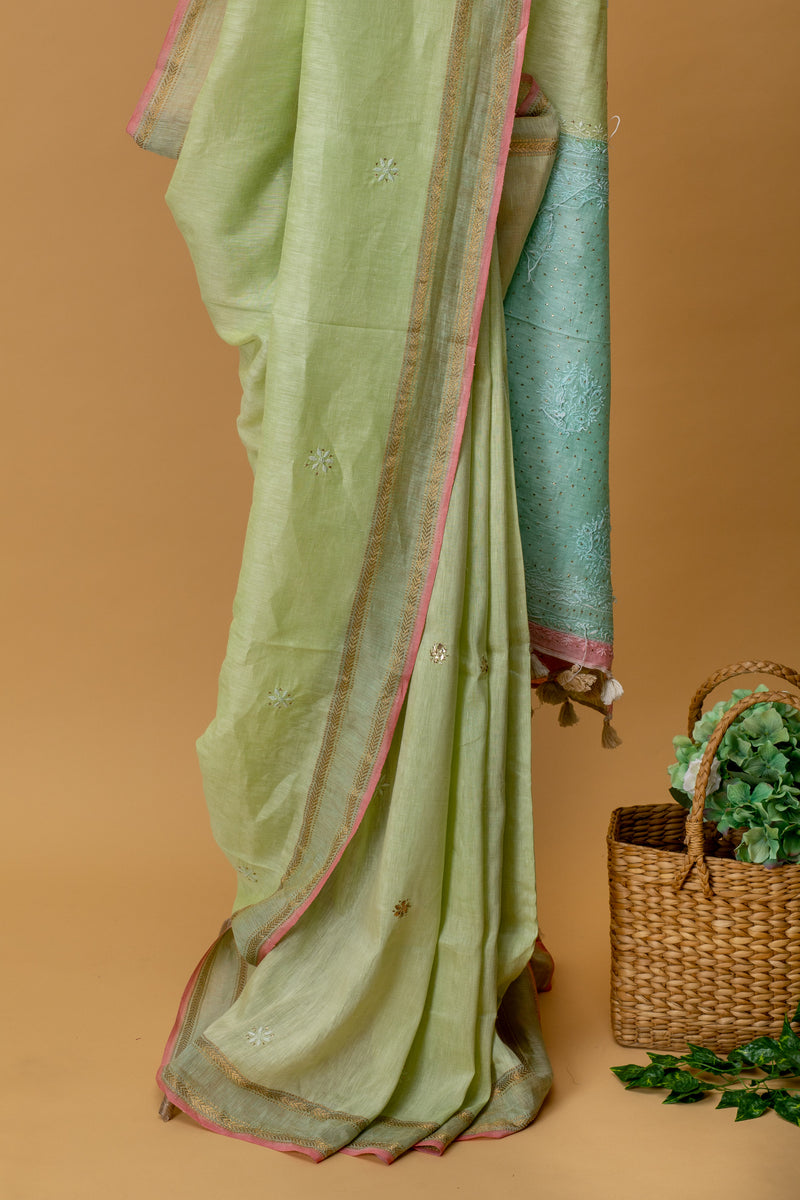 Pista green pure linen saree with delicate Chikankari bootis and pita kaamdani work by Roliana Weaves. Shop exclusive collection of hand crafted sarees by Roliana Banaras. Ekaya, Tifli