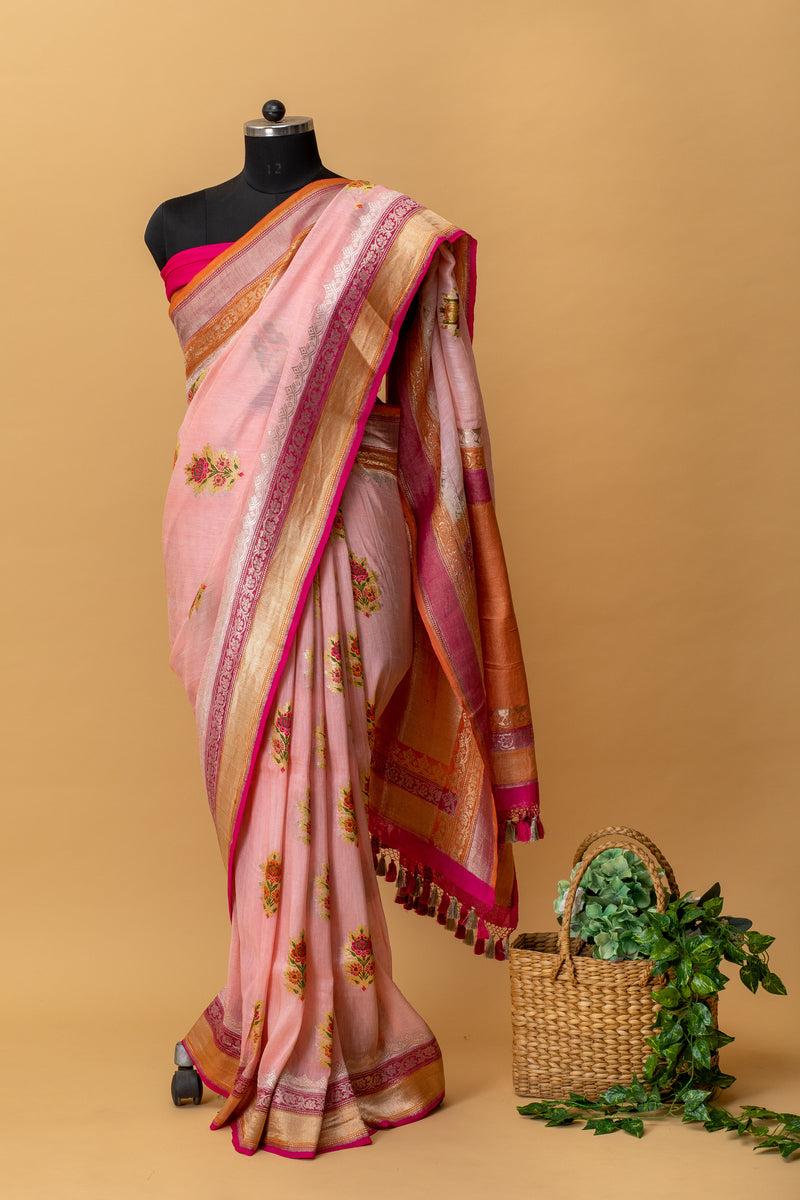 Powder pink floral meenakari pure Linen Saree with silver gold zari bootas by Roliana Weaves. Shop handcrafted summer sarees by Roliana Banaras. Ekaya Tifli