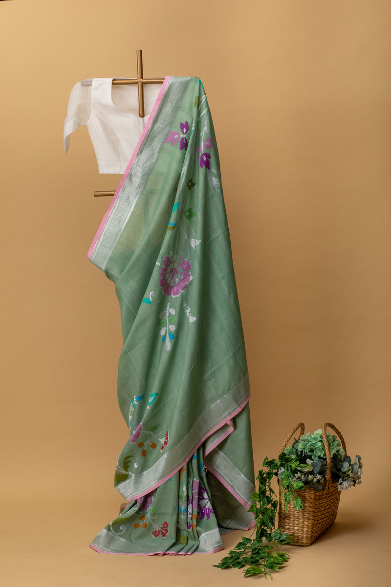 Green tussar georgette handwoven pure banarasi saree with a spray of meenakari by Roliana Weaves. Shop exclusive handwoven sarees this summer at Roliana Benaras online store.