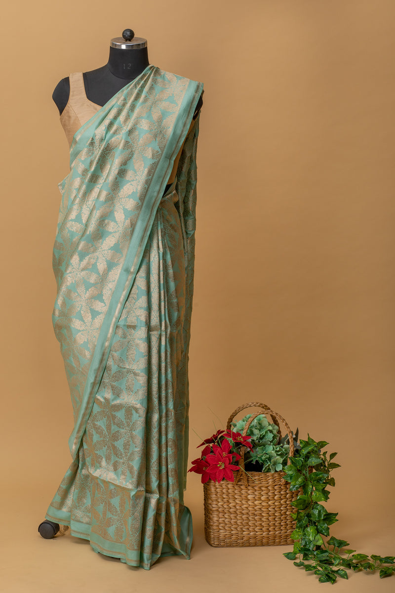 Aqua blue colour handwoven pure banarasi chanderi silk saree with all over floral bootas in geometric pattern by Roliana Weaves. Shop exclusive benarasi sarees this at Roliana online shop.