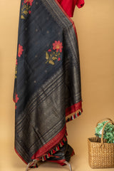 Charcoal black handwoven tussar georgette saree with silver zari bootas and handpainted red flower motifs by Roliana Weaves. Shop exclusive pure handwoven banarasi sarees at our online shop.