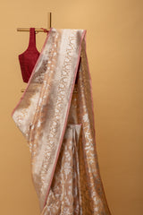 Blush pink pure handwoven benarasi tissue saree with silver tissue phool jangla all over by Roliana Weaves. Best Banarasi sari online