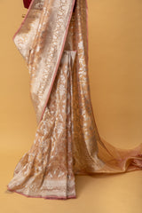 Blush pink pure handwoven benarasi tissue saree with silver tissue phool jangla all over by Roliana Weaves. Best Banarasi sari online